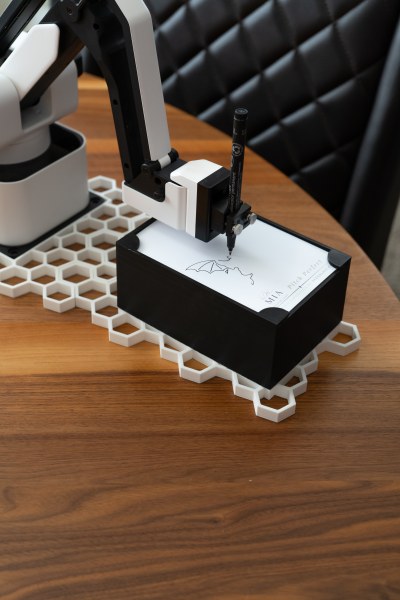 Robotic arm drawing a caricature close up